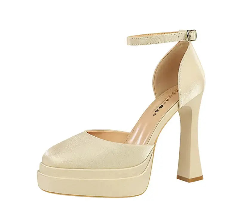 Beige high-heeled platform shoe on a white background