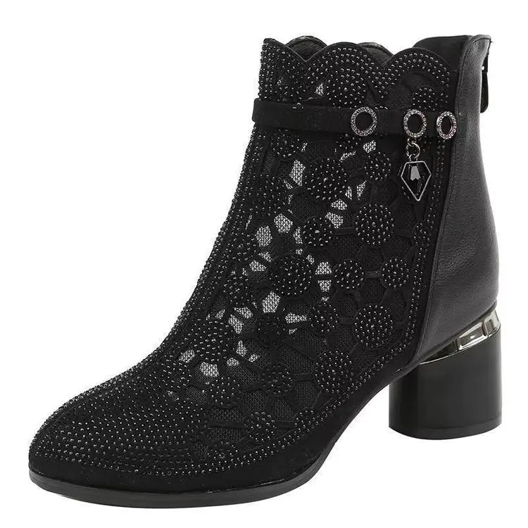 Black ankle boot with floral pattern and rhinestone details on a white background