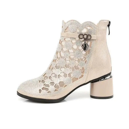Beige ankle boot with lace design on a white background