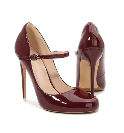 Pair of burgundy high-heeled shoes with a strap on a white background
